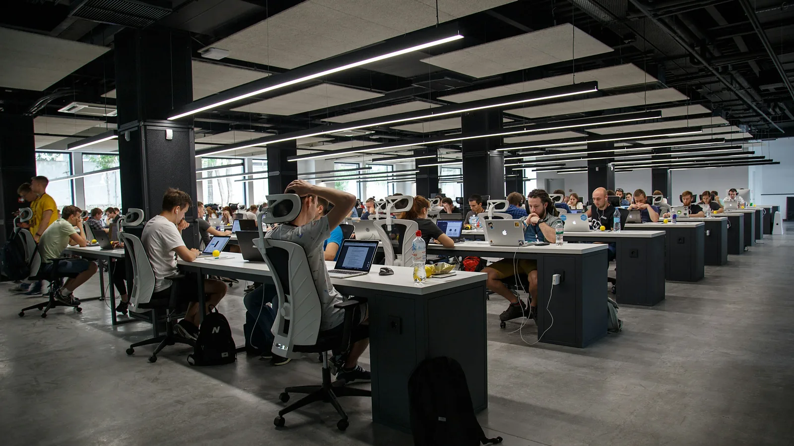 A large open-plan office with many people working at their desks