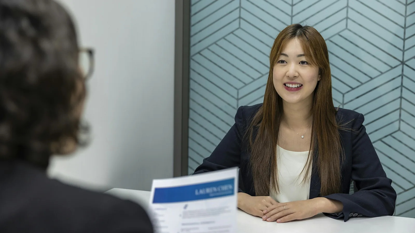 A candidate holding her resume during a job interview