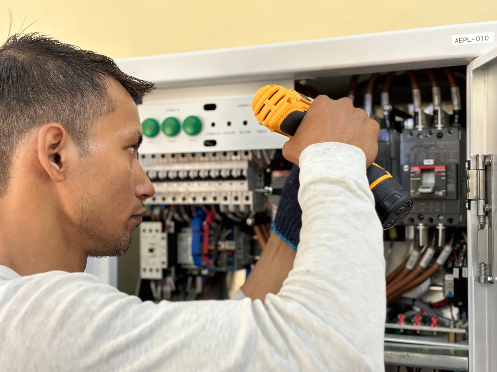 Electrician working on an electrical panel