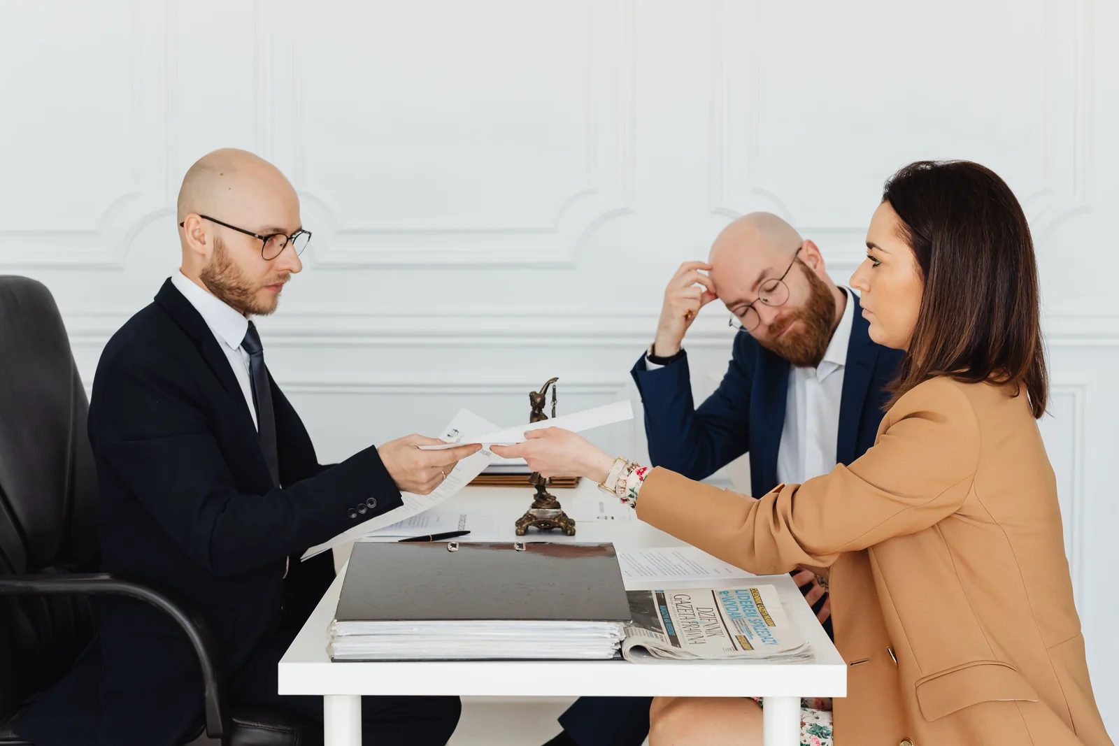 Attorneys meeting a client at a desk