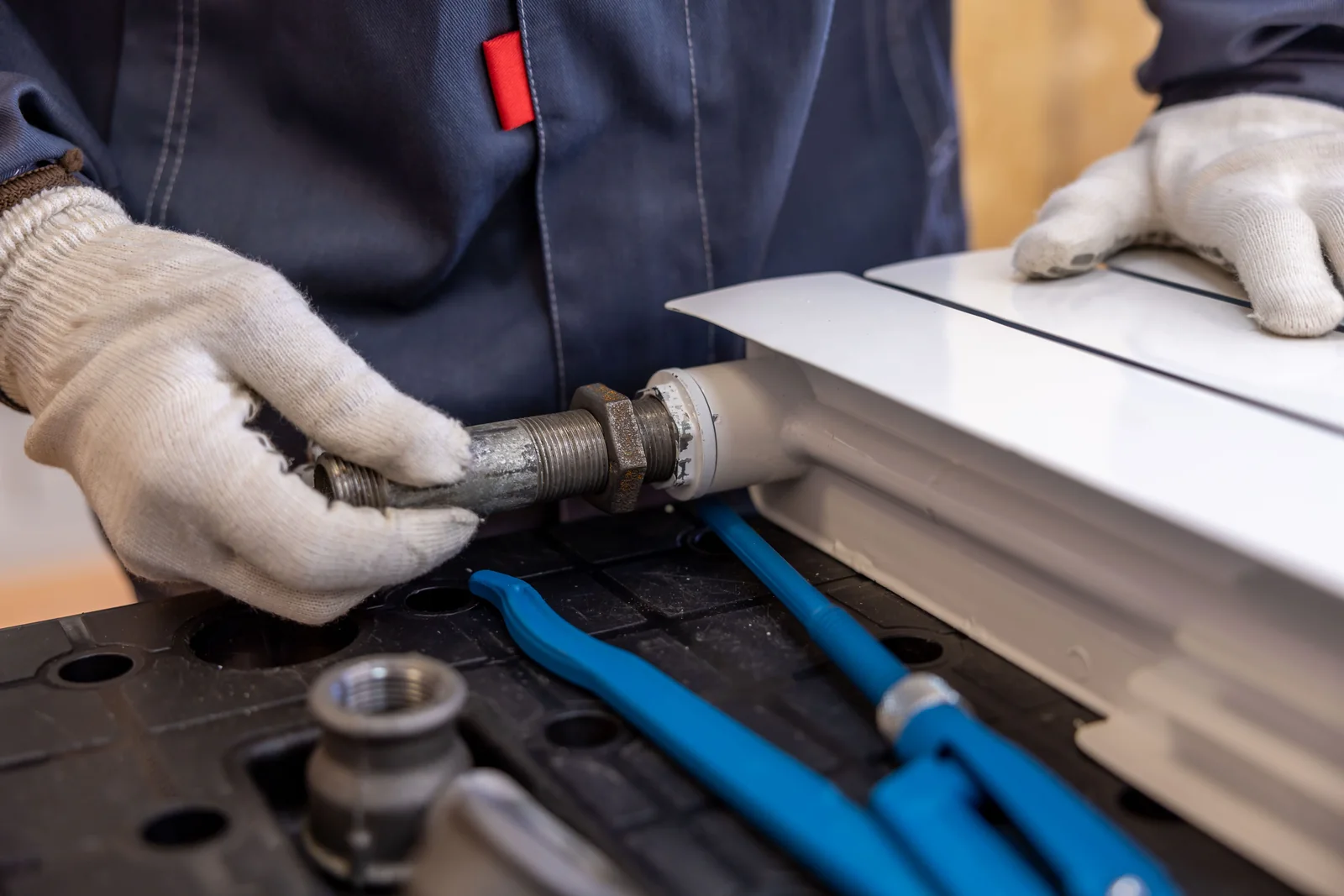 Plumber tightening a pipe fitting